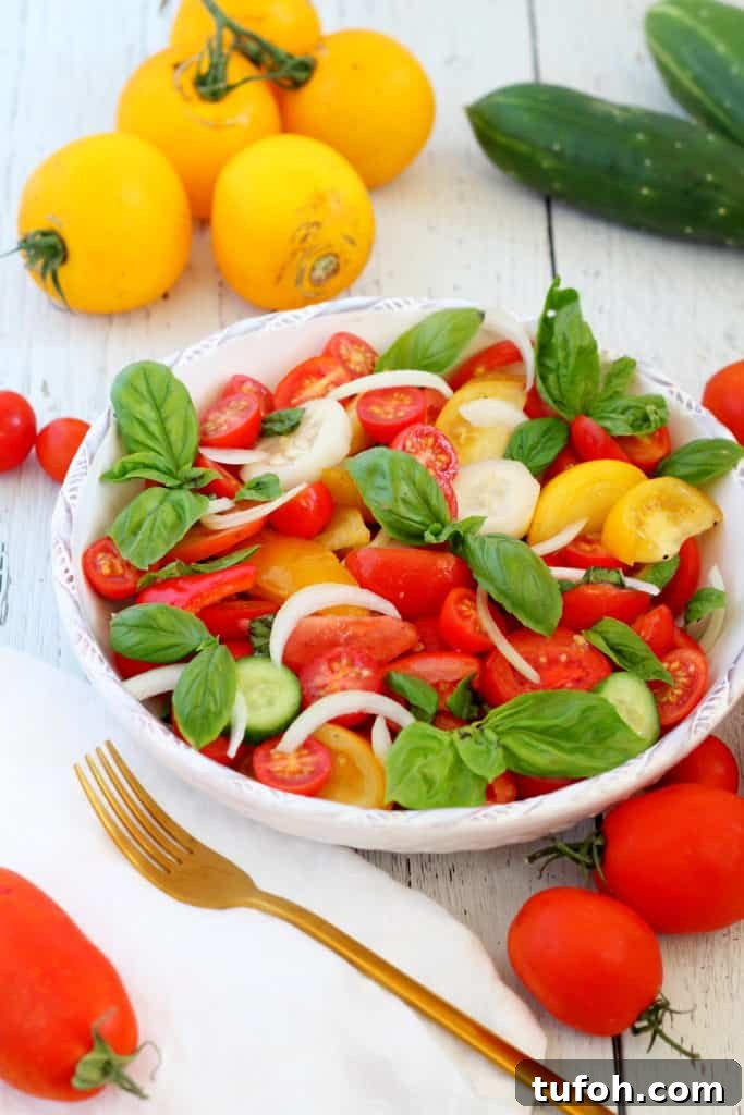Crisp Tomato & Cucumber Salad with Lemon Vinaigrette 2 tomato and cucumber salad in white bowl