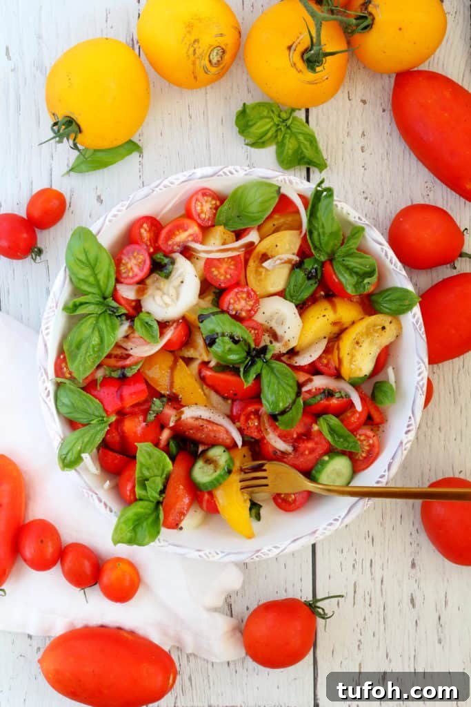 Crisp Tomato & Cucumber Salad with Lemon Vinaigrette 6 tomato salad with basil and cucumber in white plate