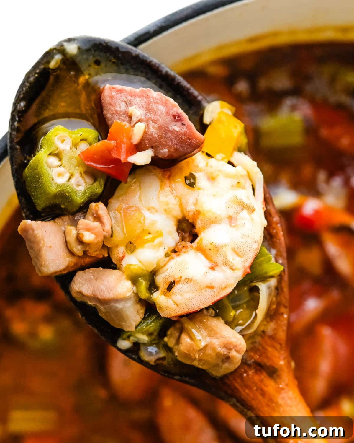 Scooping up some of the meats and seafood from the gumbo stew.