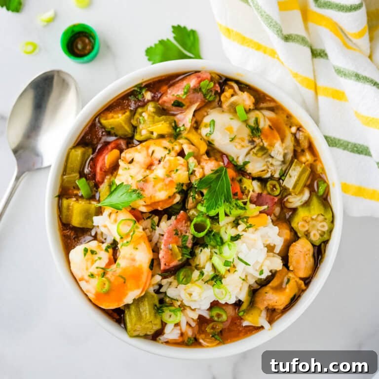 A bowl of chicken and sausage gumbo with shrimp.