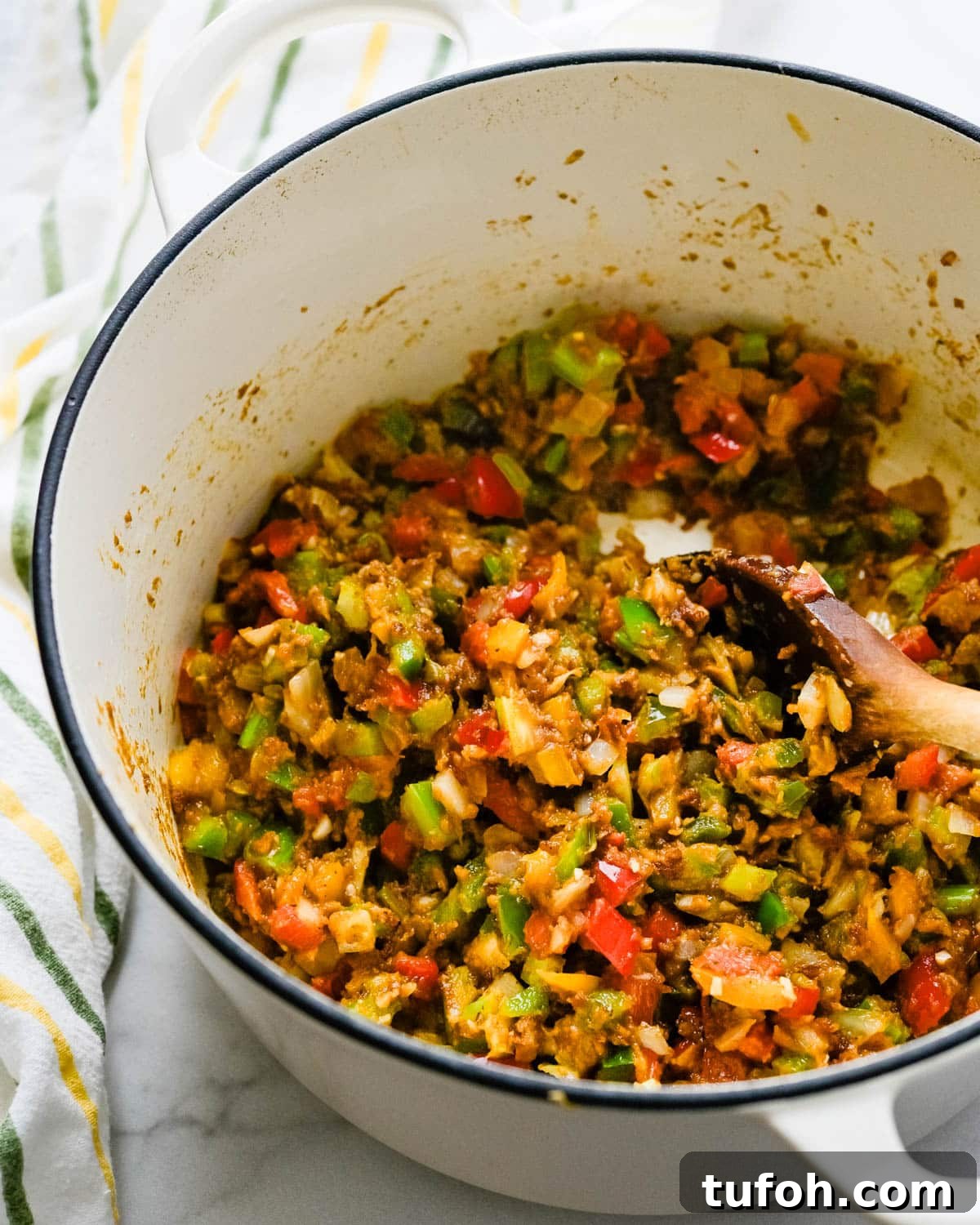 Mixing the vegetables into the roux.