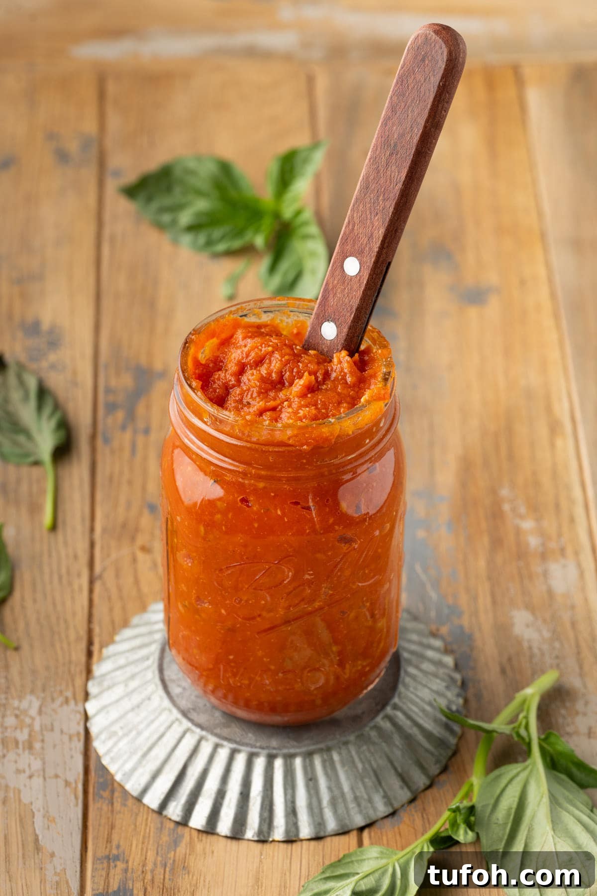 Mason jar filled with homemade pizza sauce made from roasted tomatoes. 