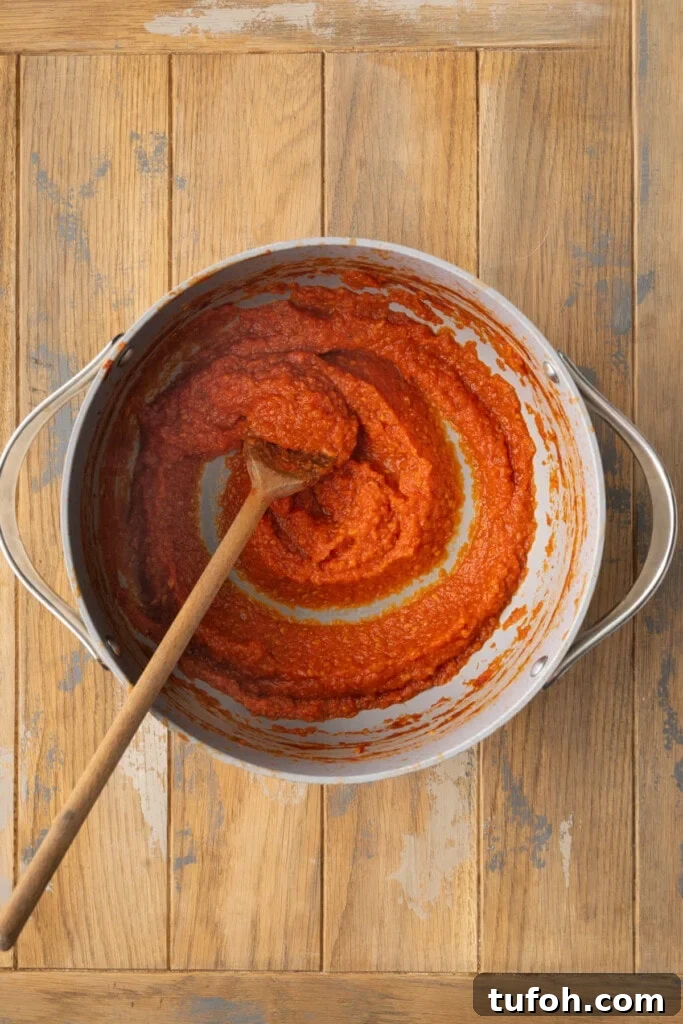 Pizza sauce in a pot thickened on the stove. 
