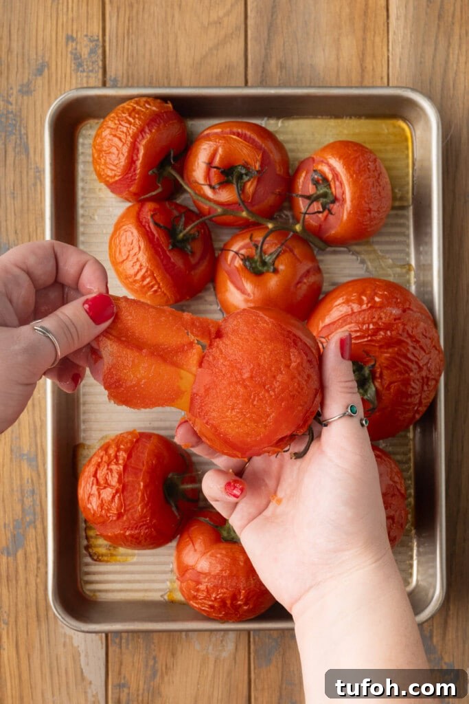 Easily peeling the outer skin off of a roasted tomato.
