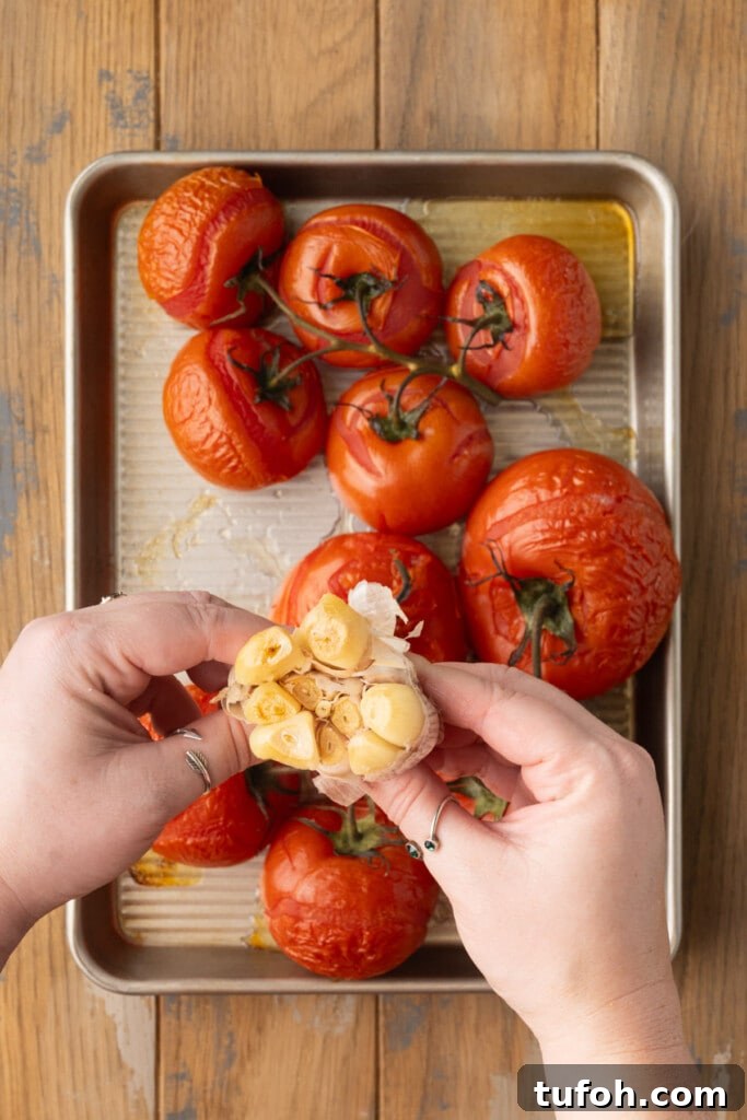 Squeezing roasted garlic out of the peels.