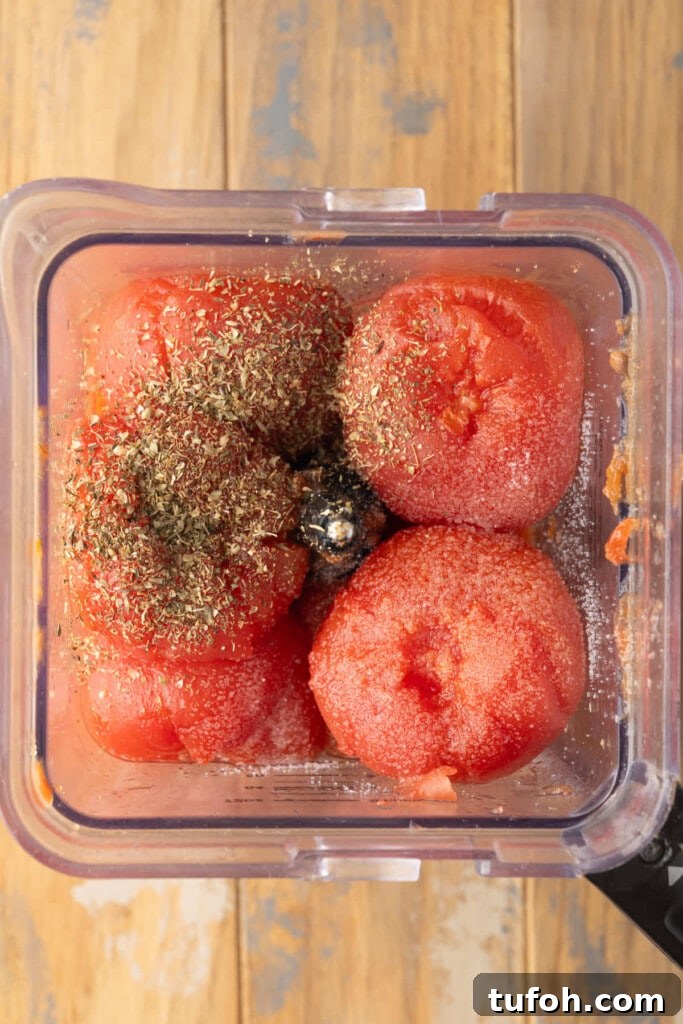 Peeled roasted tomatoes, roasted garlic cloves, salt, and dried oregano in a blender. 