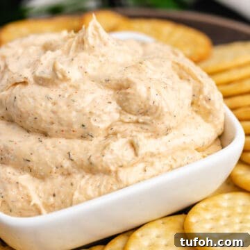 Square white bowl filled with ranch dip.