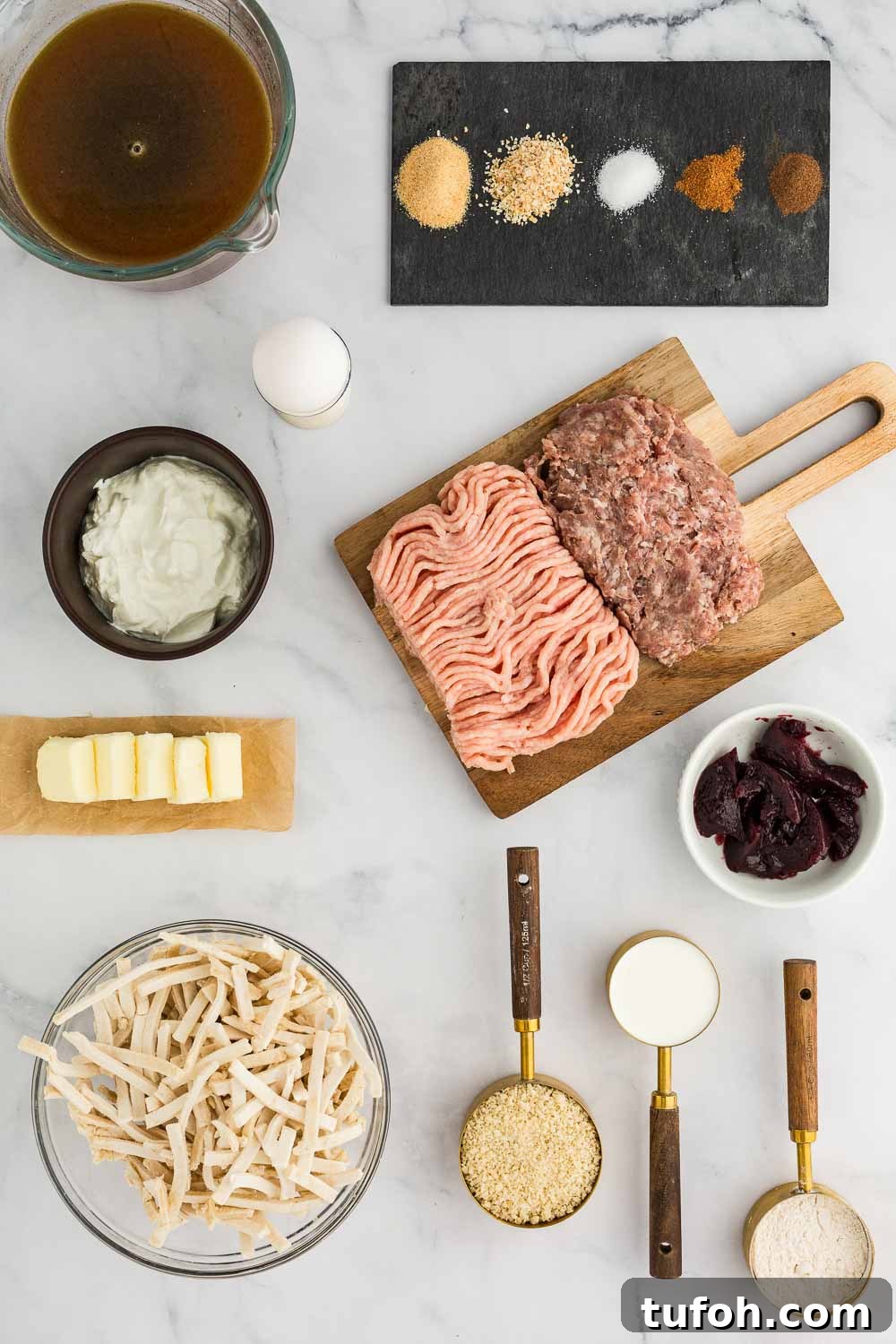 Swedish Meatballs in Slow Cooker with Creamy Sauce 3 multiple ingredients including ground chicken and pork, spices, cheeses, butter, and butter displayed on table