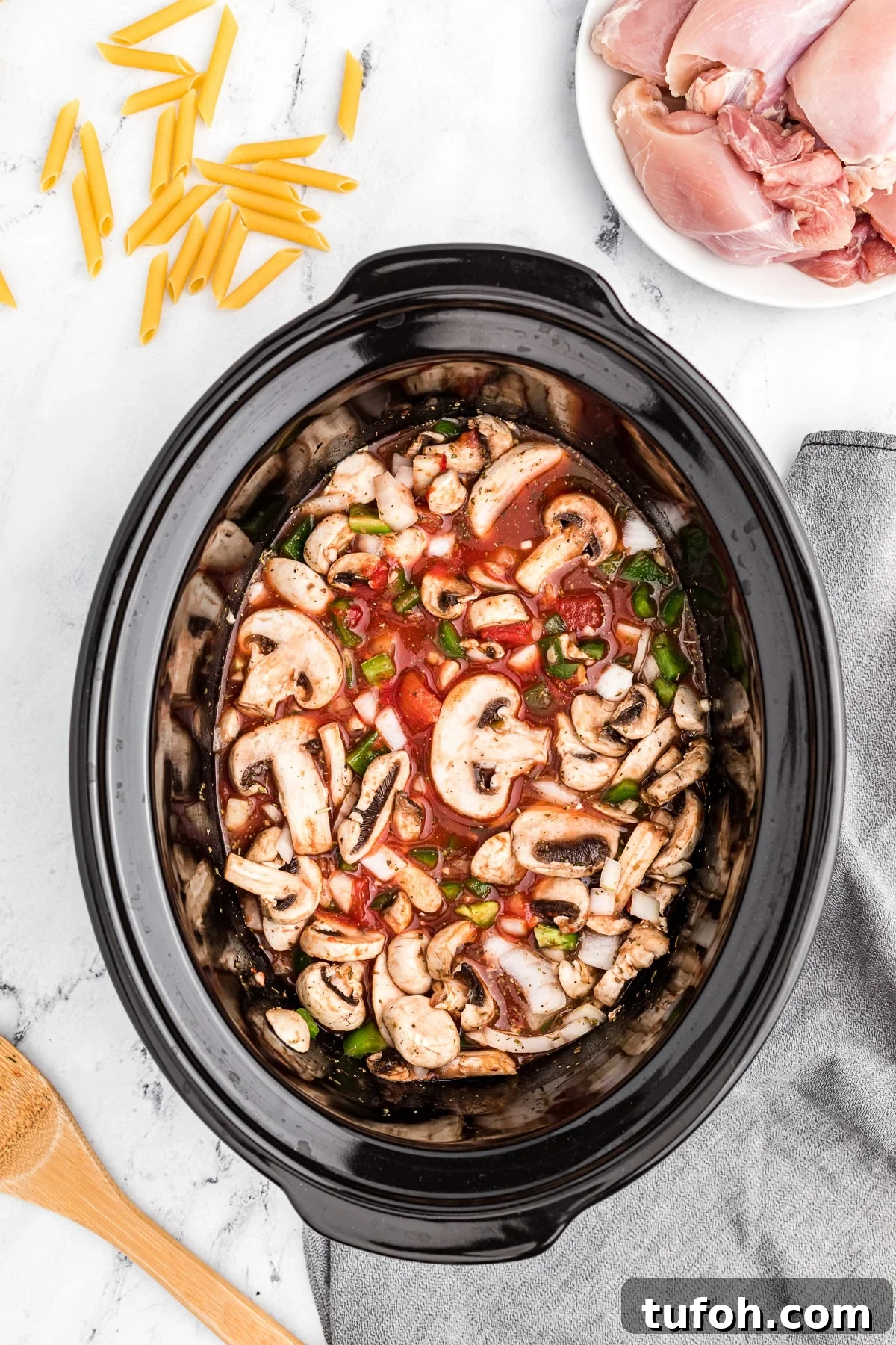 Veggies in a tomato sauce in a slow cooker.