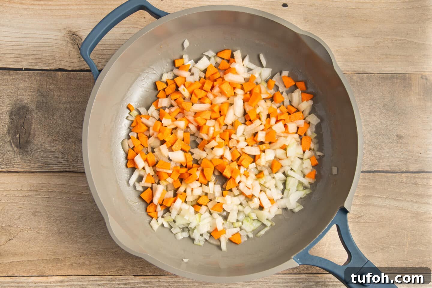 Creamy Tomato and Cottage Cheese Pasta Sauce Recipe 5 This is a picture of a skillet with onion and carrot cooking.