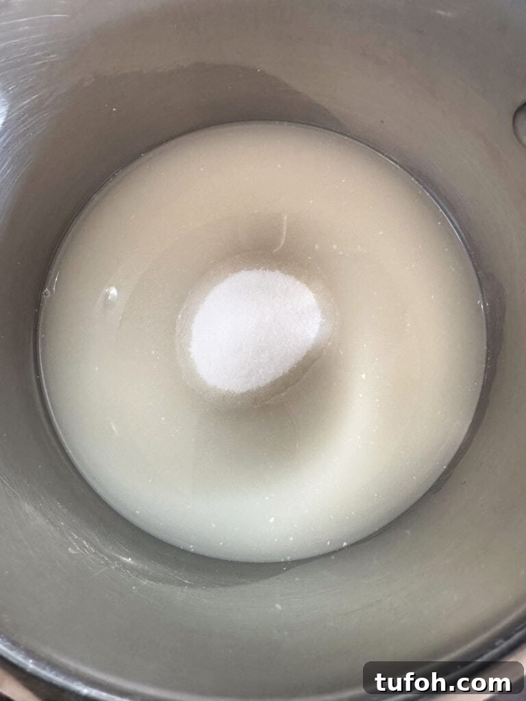 This homemade coconut sorbet is bursting with tropical flavor! Made with coconut milk and simple ingredients for a refreshing summer dessert. sugar and water in pot