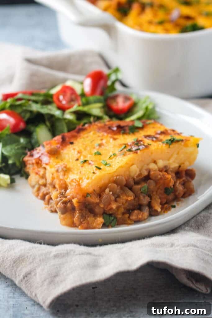 Close up of the lentil filling in a slice of vegan shepherd's pie.
