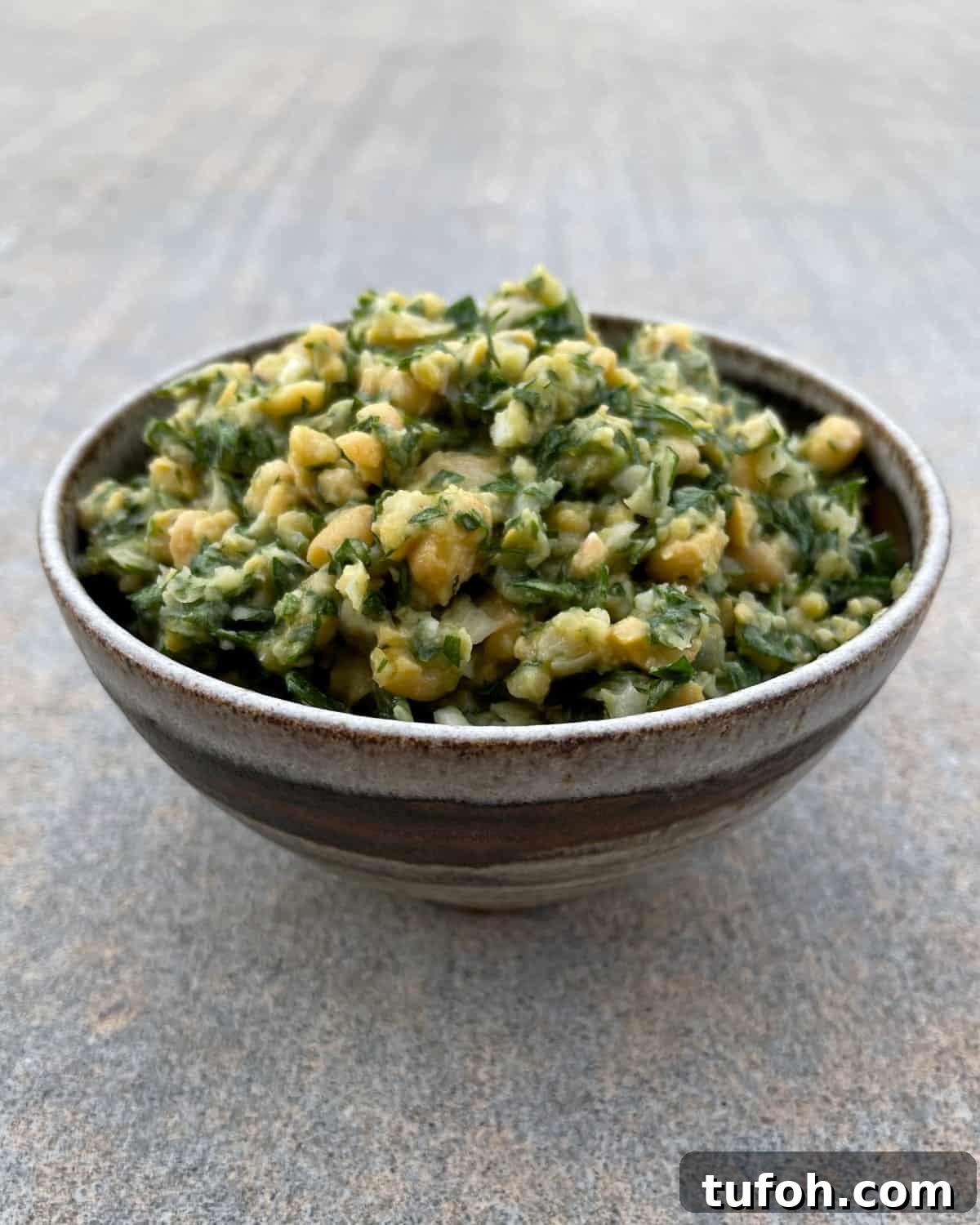 Gluten-Free Low-Carb Chickpea Tabbouleh Recipe 2 Gluten-free chickpea tabbouleh in brown ceramic bowl.