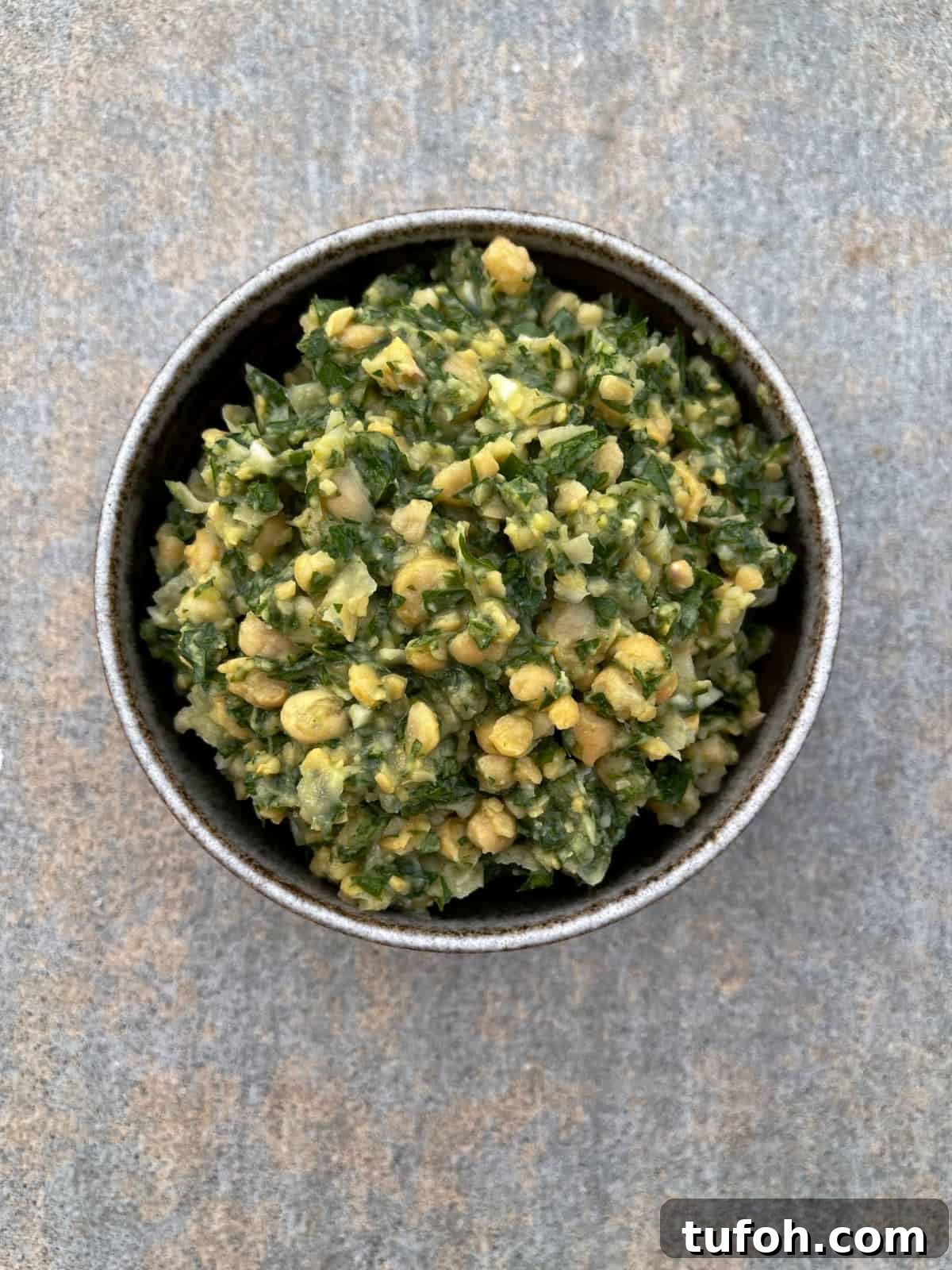 Gluten-Free Low-Carb Chickpea Tabbouleh Recipe 7 Fresh made garbanzo bean tabbouleh in brown bowl.