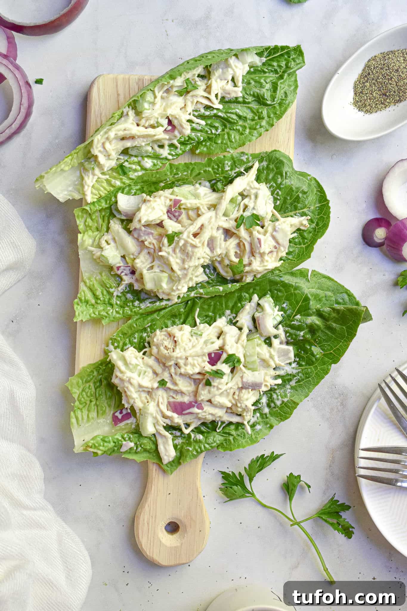 Instant Pot Chicken Salad Recipe for Quick Weeknight Meals 4 The instant pot chicken salad is on romaine lettuce on a cutting board.