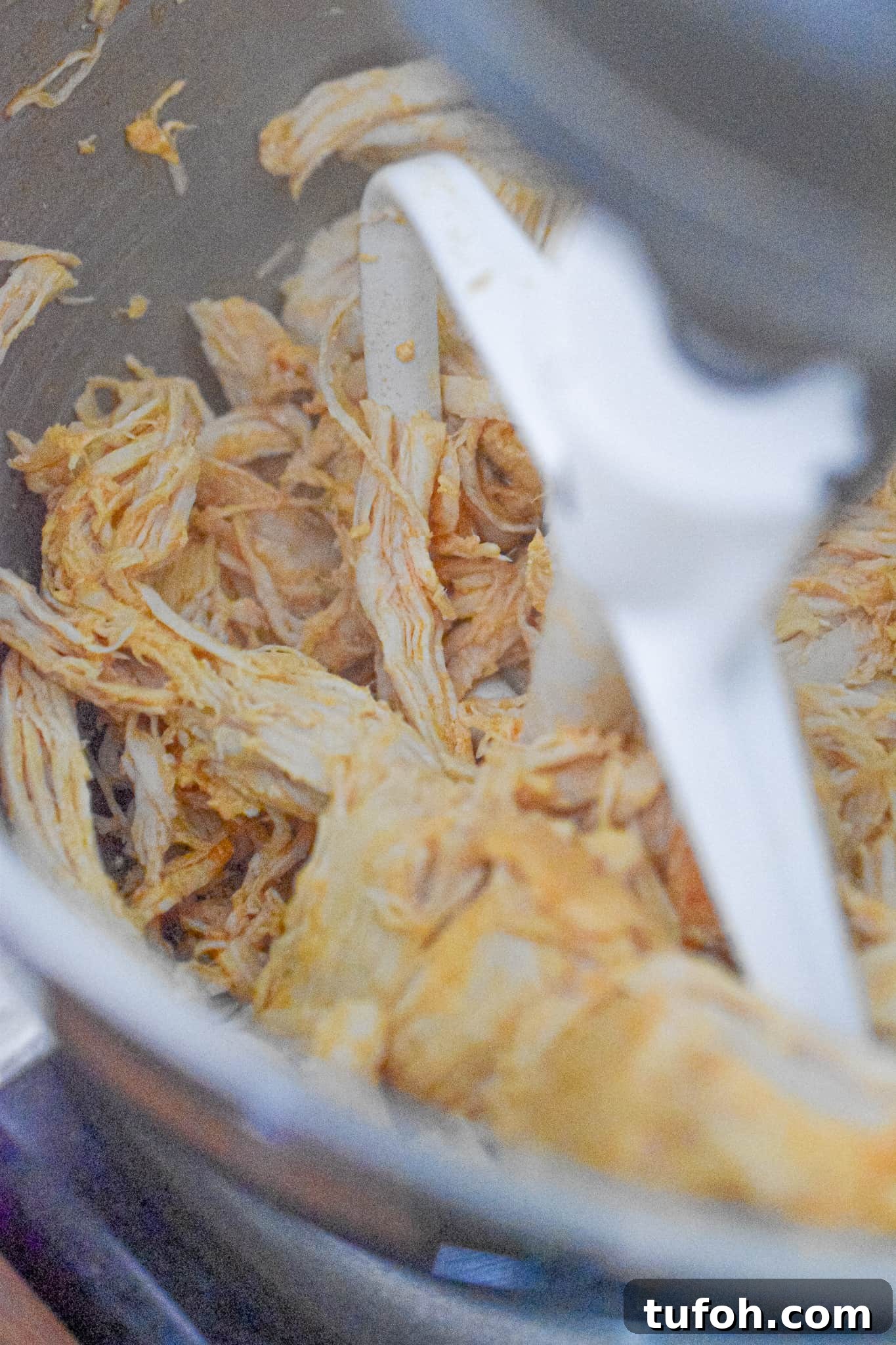 Instant Pot Chicken Salad Recipe for Quick Weeknight Meals 8 The chicken is being shredded in a stand mixer.
