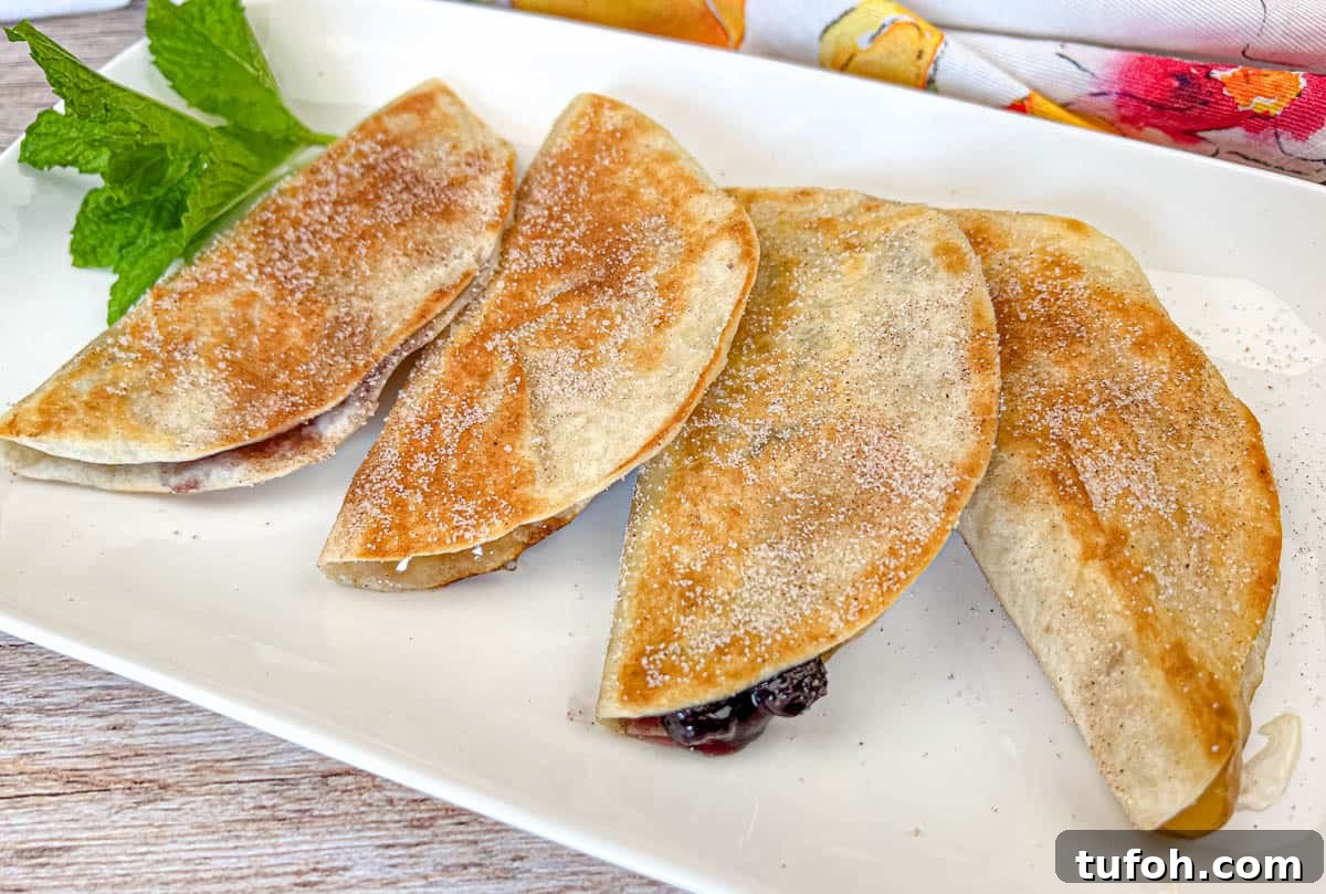 17 Crowd-Pleasing Backyard BBQ Recipes for Seconds-Worthy Meals 14 Four pieces of Fruit Quesadillas on a white plate.