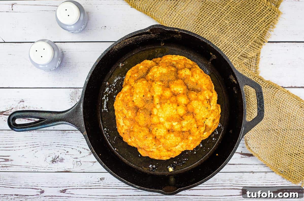 17 Crowd-Pleasing Backyard BBQ Recipes for Seconds-Worthy Meals 19 Smoked cauliflower in a skillet on a wooden table.