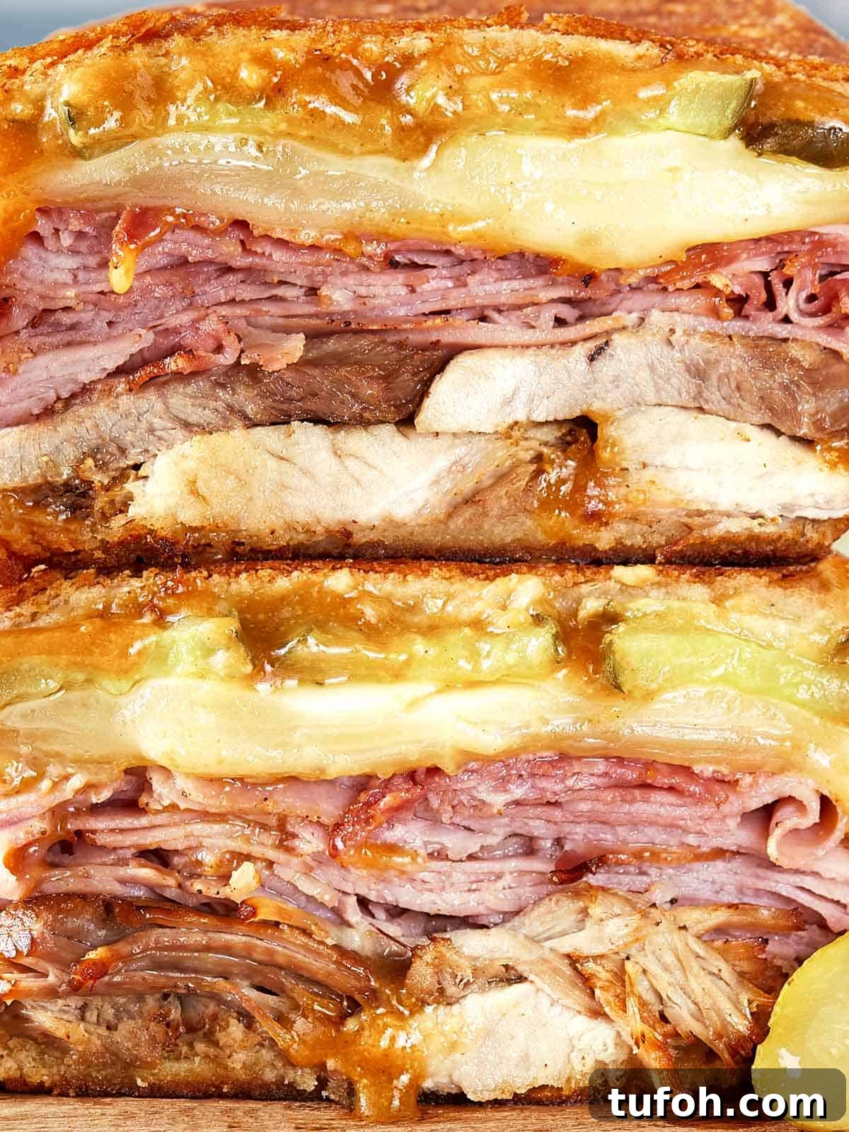 Close-up of a stacked Cuban sandwich.
