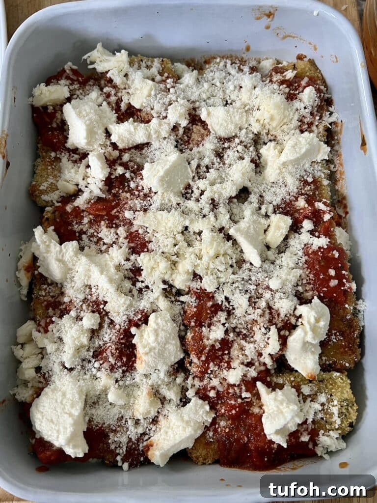 Zucchini Parmigiana with Ricotta: Layered Baked Zucchini Parmesan 13 Continuing the layering process with another layer of cheeses..