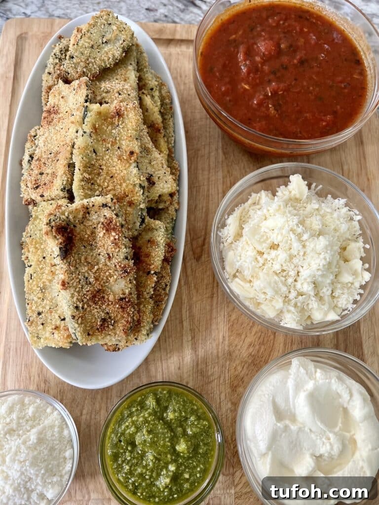Zucchini Parmigiana with Ricotta: Layered Baked Zucchini Parmesan 5 Ingredients for zucchini parmesan on cutting board.
