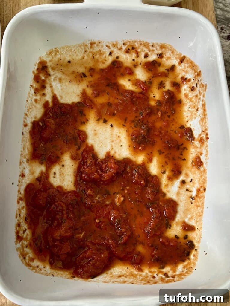 Zucchini Parmigiana with Ricotta: Layered Baked Zucchini Parmesan 6 Building the recipe: tomato sauce on bottom of baking dish.