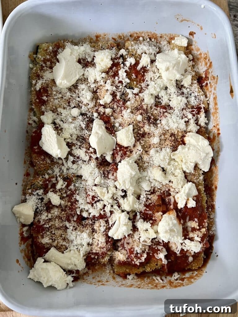 Zucchini Parmigiana with Ricotta: Layered Baked Zucchini Parmesan 9 Building the zucchini parm: Mozzarella and grated cheese added as the next step.