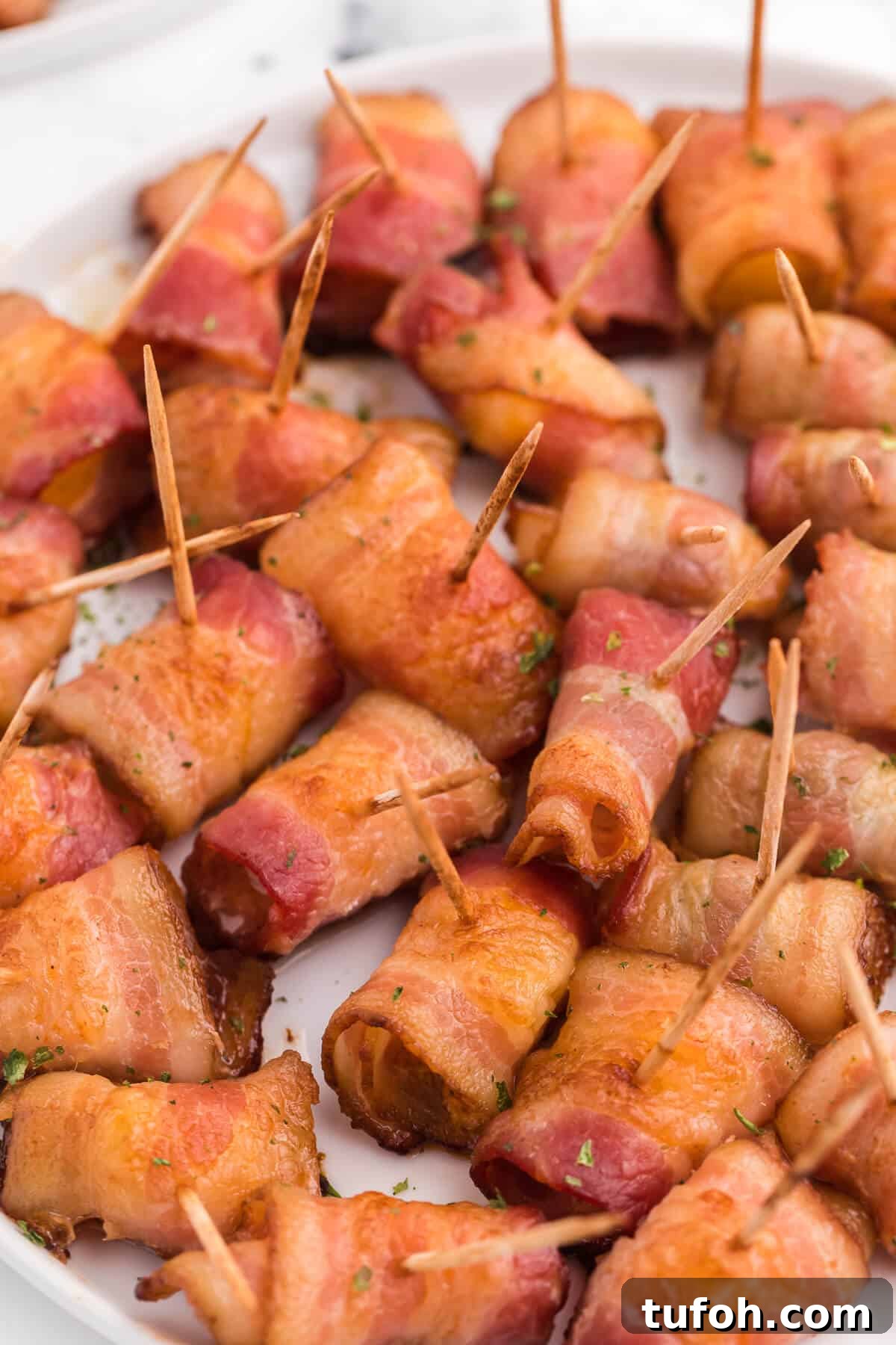 Bacon Wrapped Appetizers - Bite sized and addicting! Try four varieties - bacon wrapped water chestnuts, bacon wrapped smoked oysters, bacon wrapped pineapple and bacon wrapped olives.