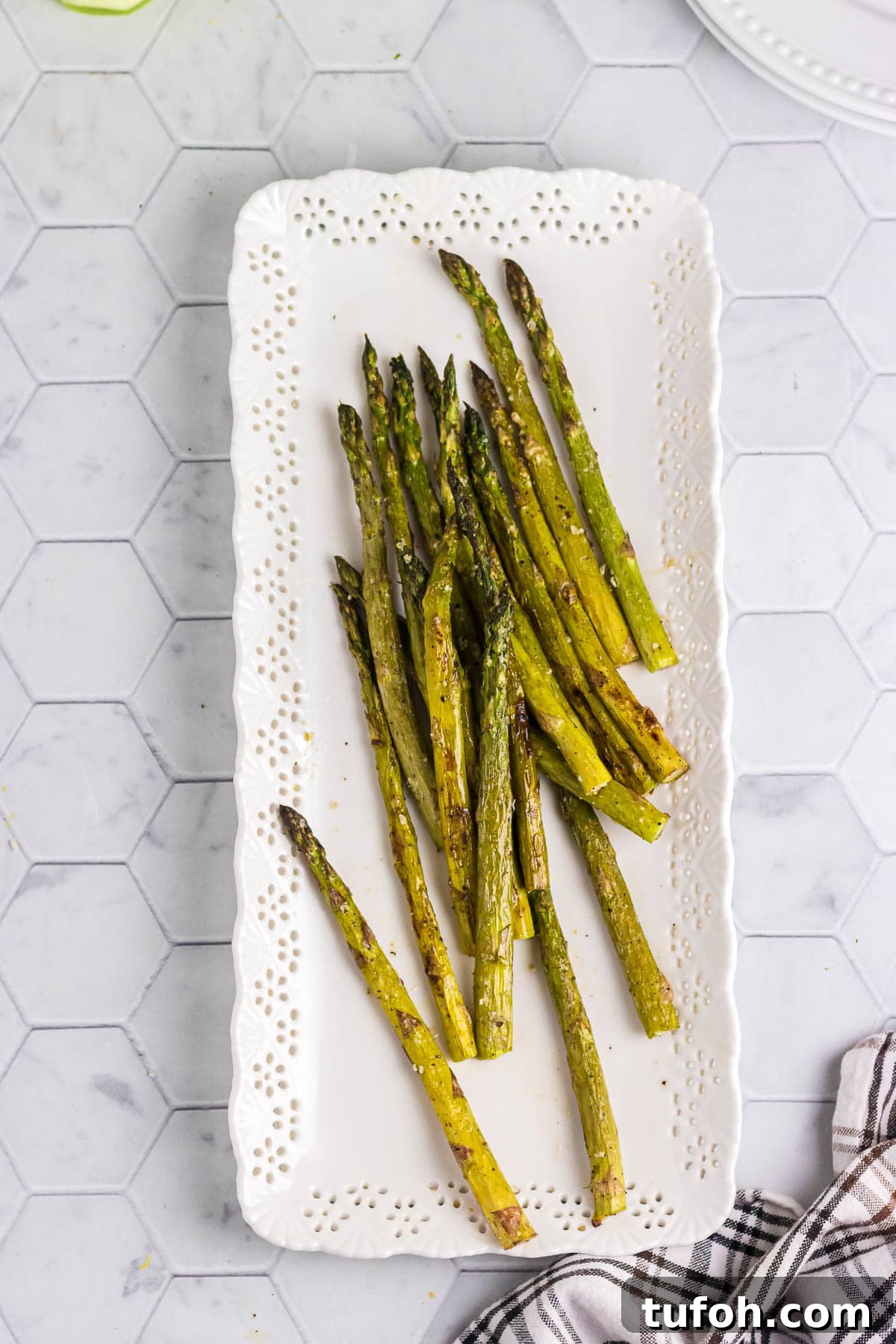 Crispy Oven-Roasted Asparagus with Garlic and Lemon 2 Roasted asparagus on a decorative serving platter.
