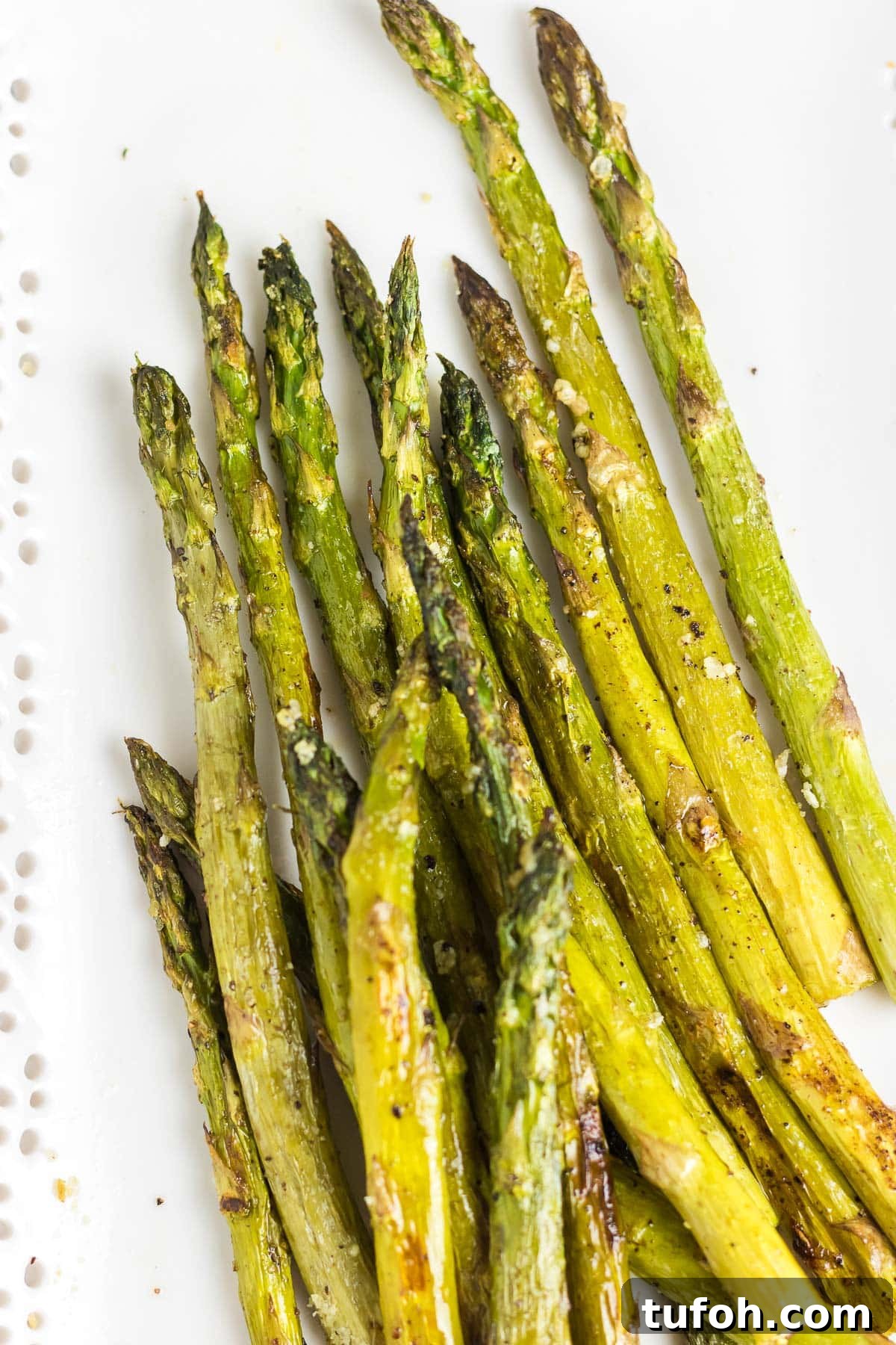 Crispy Oven-Roasted Asparagus with Garlic and Lemon 6 An up-close photo of roasted asparagus spears.