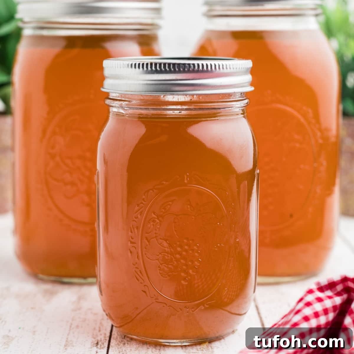 Savory Rotisserie Chicken Bone Broth Recipe for Rich Flavor 4 3 jars of Rotisserie Chicken Bone Broth, the image cropped square.