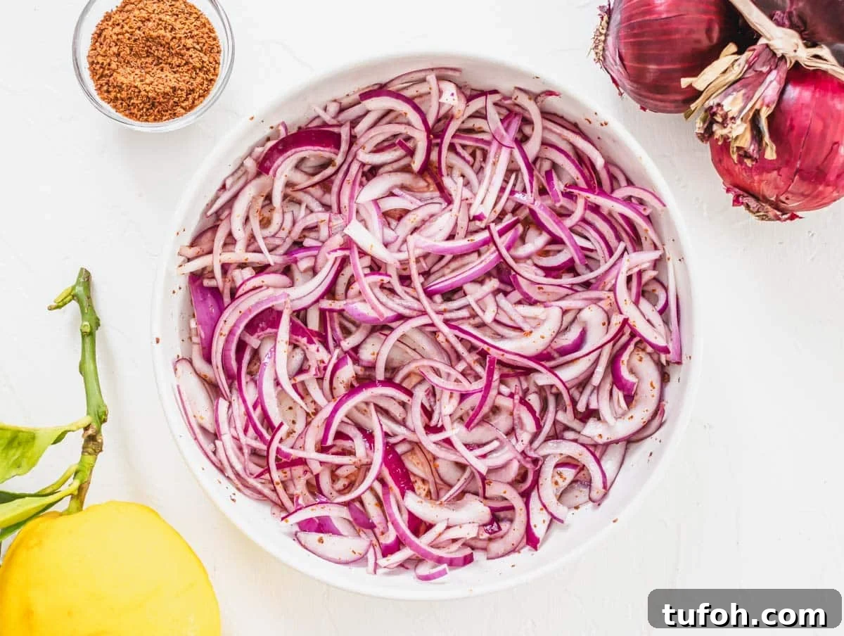Sumac onions marinating in a white bowl