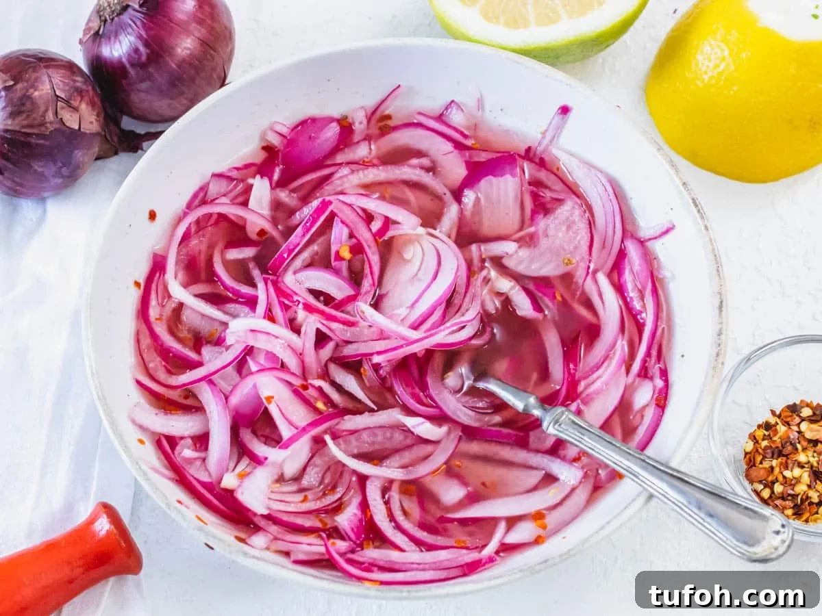 Pickled red onions with a fork