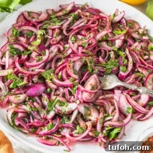 Sumac onions with a silver fork and fresh parsley