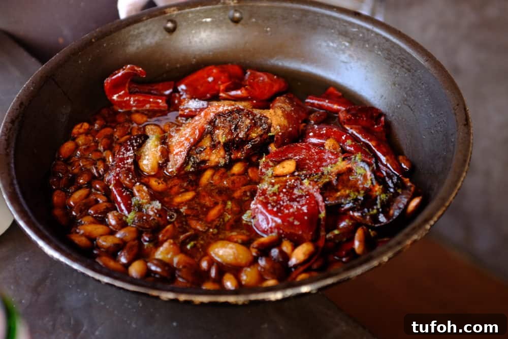 Orange-Almond Mole Sauce: Quick Recipe for Vibrant Flavor 8 A skillet filled with almonds, chiles, tomatoes, garlic, honey and spices.