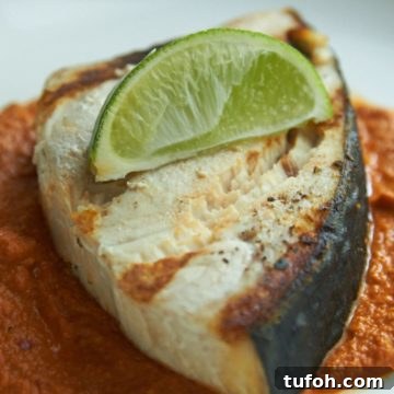 Orange-Almond Mole Sauce: Quick Recipe for Vibrant Flavor 9 Grilled halibut topped with lime on a bed of mole sauce.