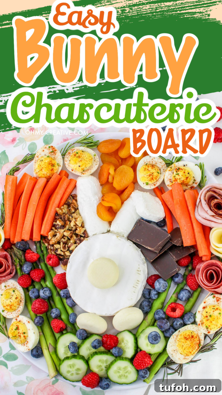 A bunny made of cheese in the center of a fruit and vegetable charcuterie board.