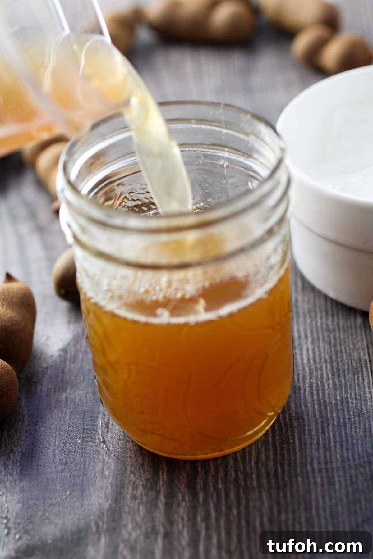 pouring tamarindo in a clear glass