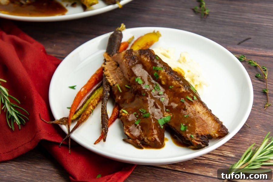 Sliced brisket with red wine gravy and carrots
