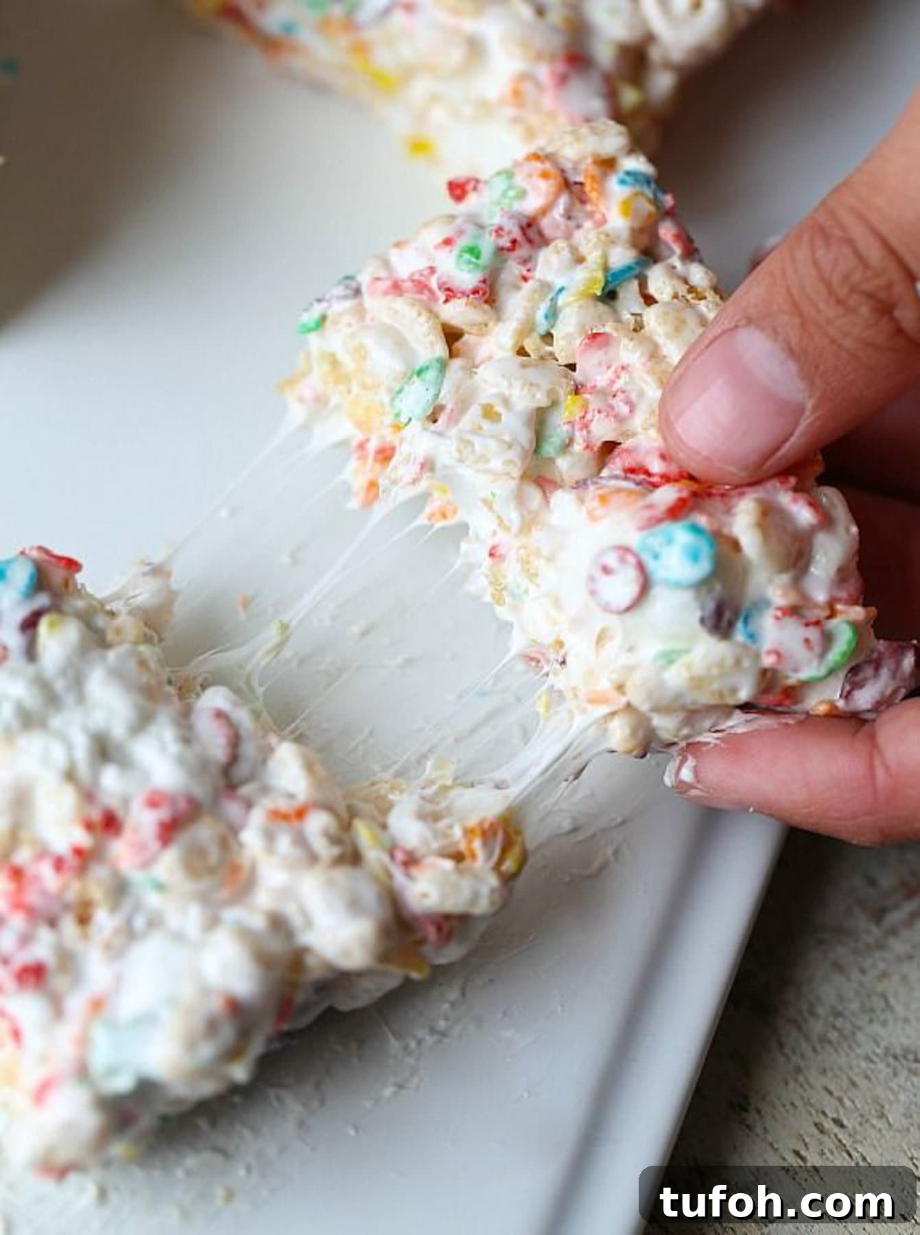 Overhead view of a Fluff Krispie Treat being broken apart