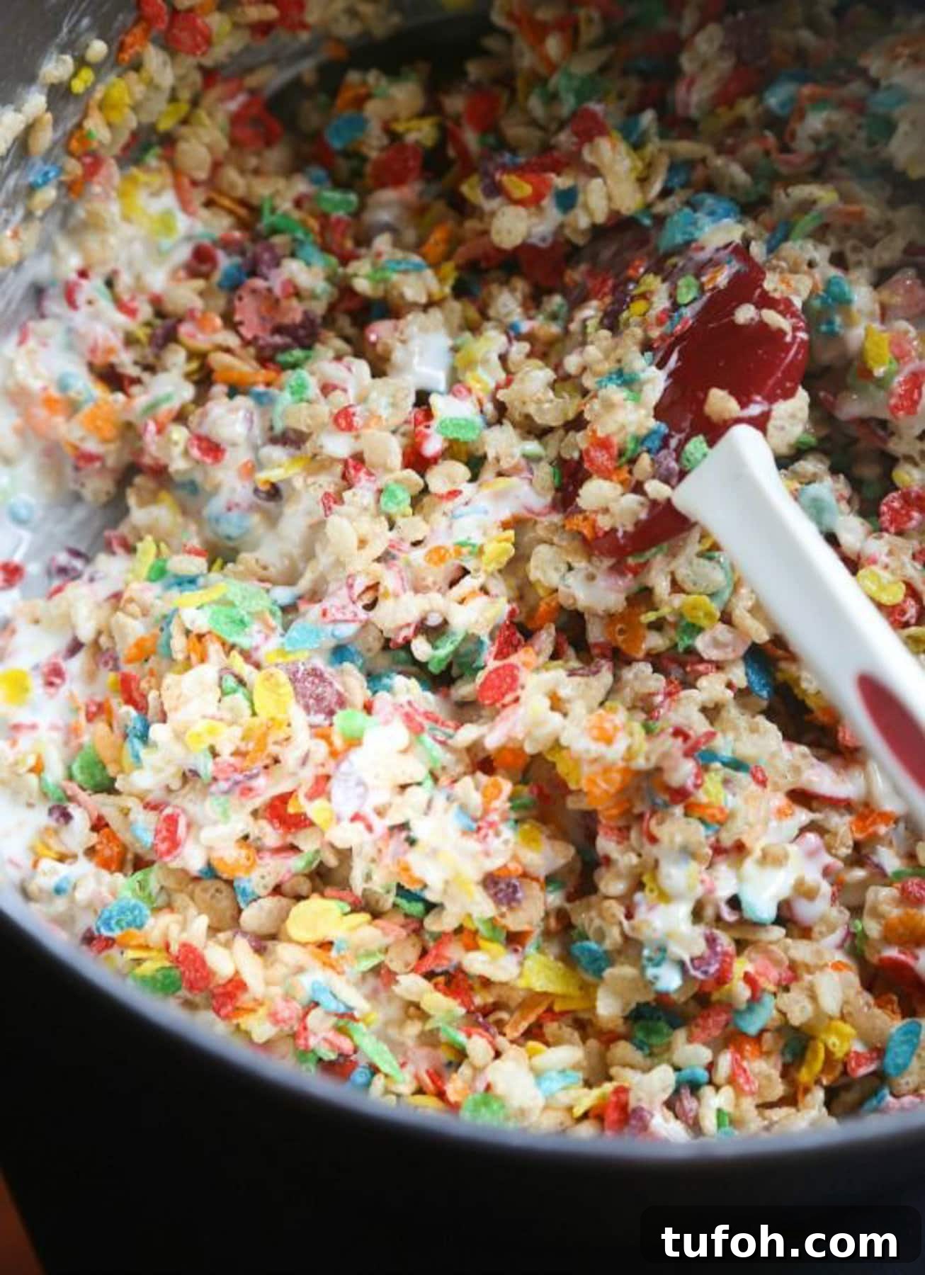 Overhead view of Krispie Treats with fluff being mixed in a bowl