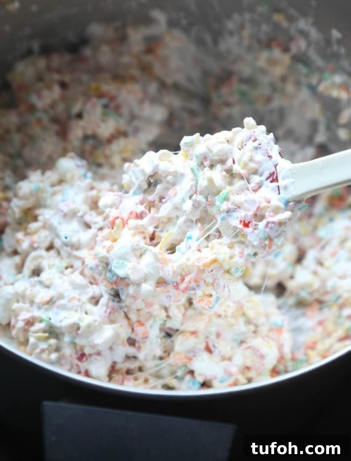 Mixture of Krispie Treats made with Fluff and mini marshmallows in a bowl