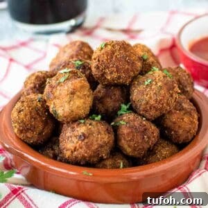 Fried Meatballs piled into a shallow terracotta bowl.