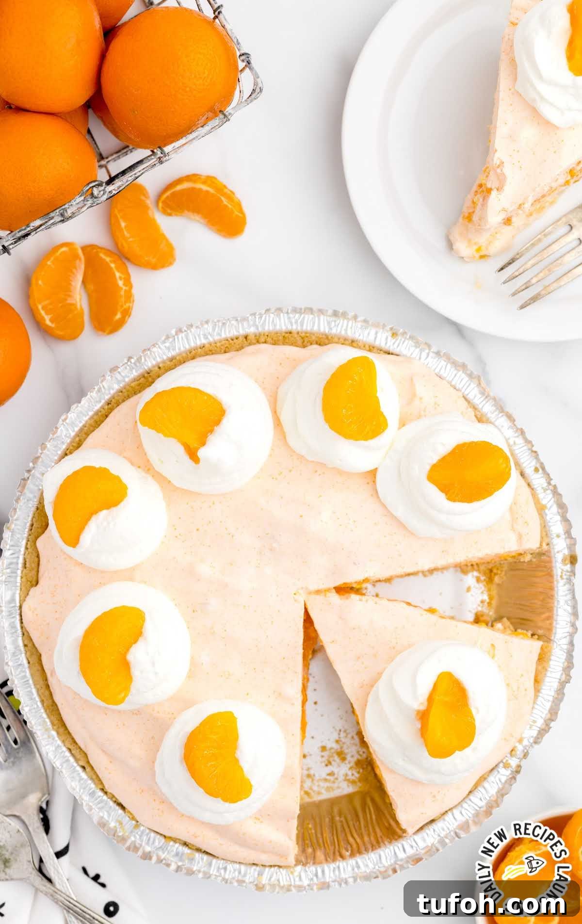overhead shot of a pie topped with whipped cream and mandarin oranges