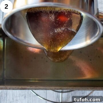 Liquid caramelized sugar being poured into a pan.