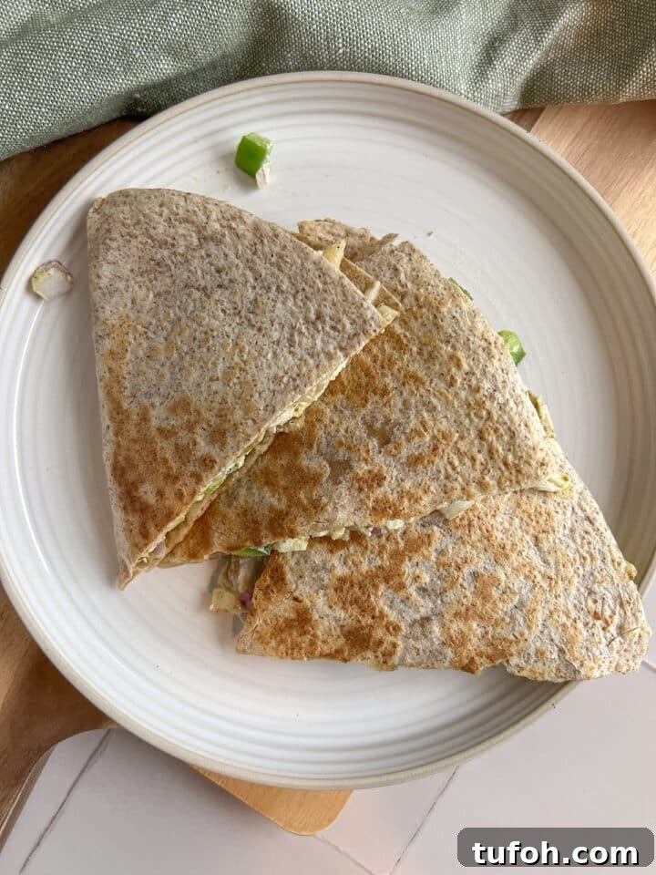 Pesto chicken quesadilla triangles sliced and displayed on a white plate