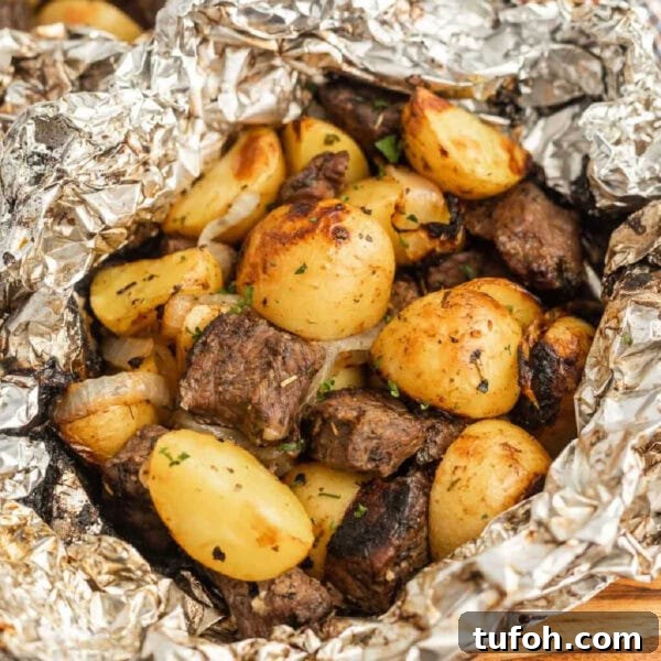 Grilled steak and potatoes in foil.
