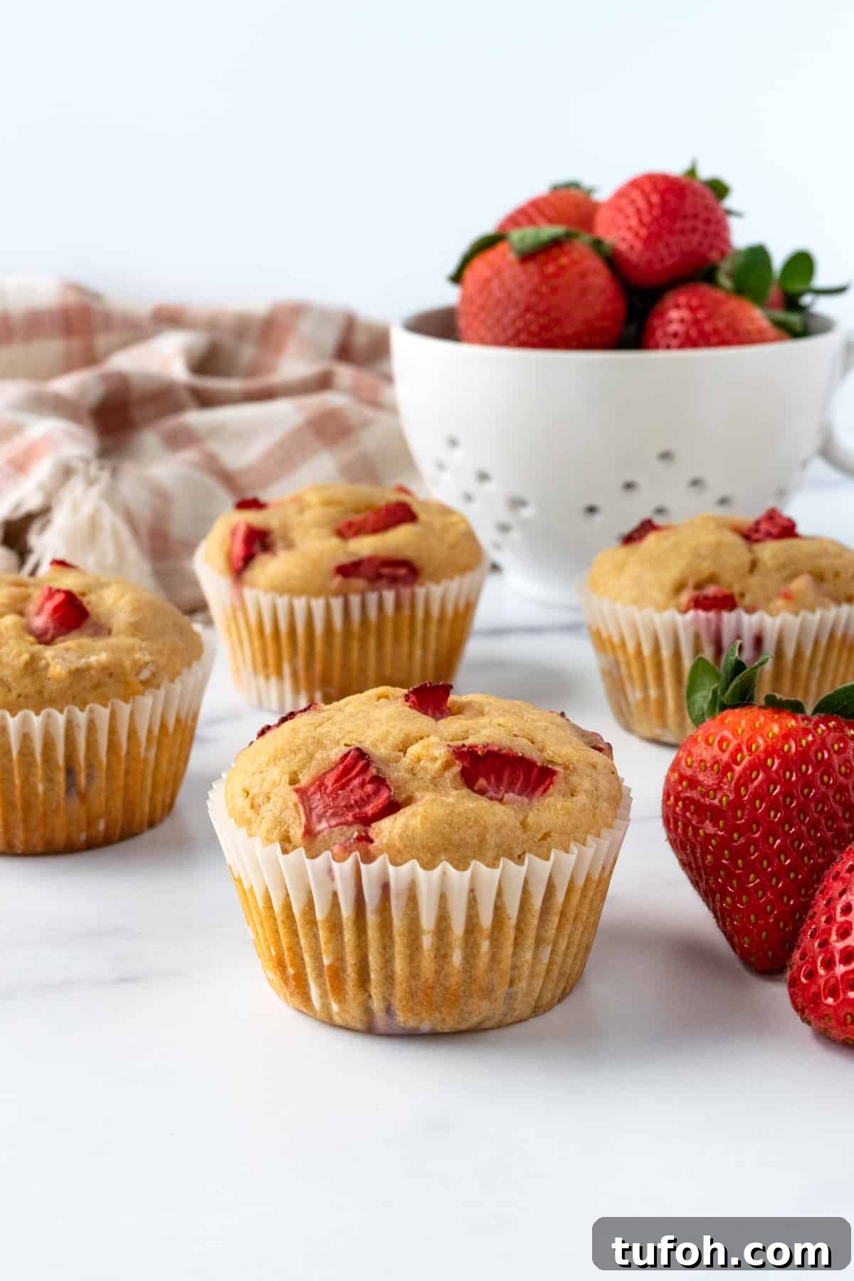 Strawberry Lemon Muffins on a white table.