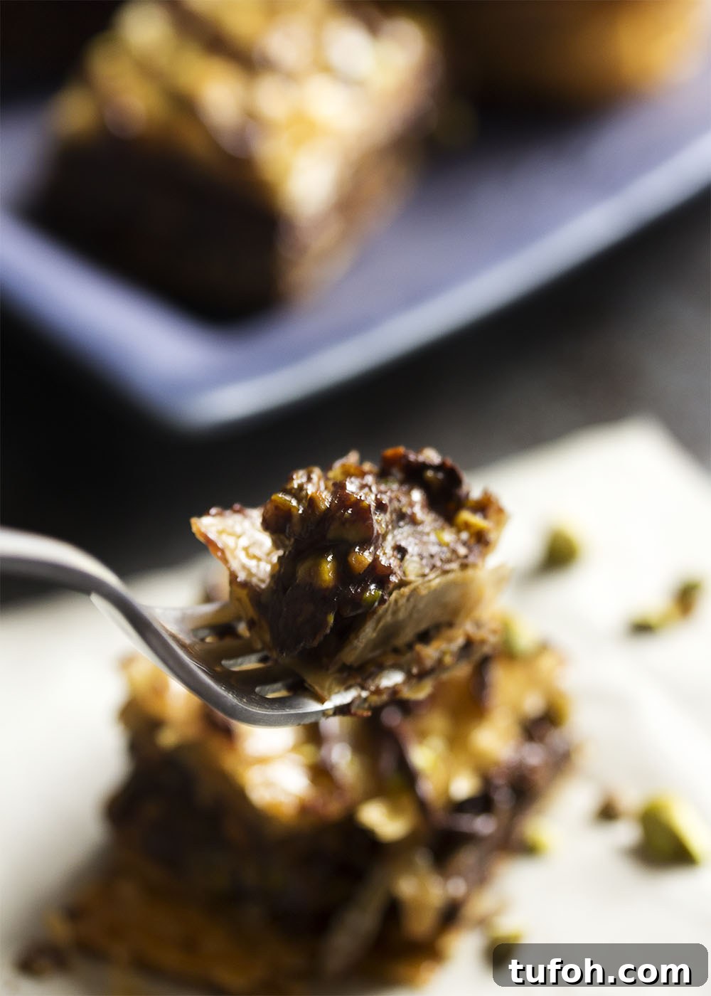 Sliced chocolate pistachio baklava drizzled with honey