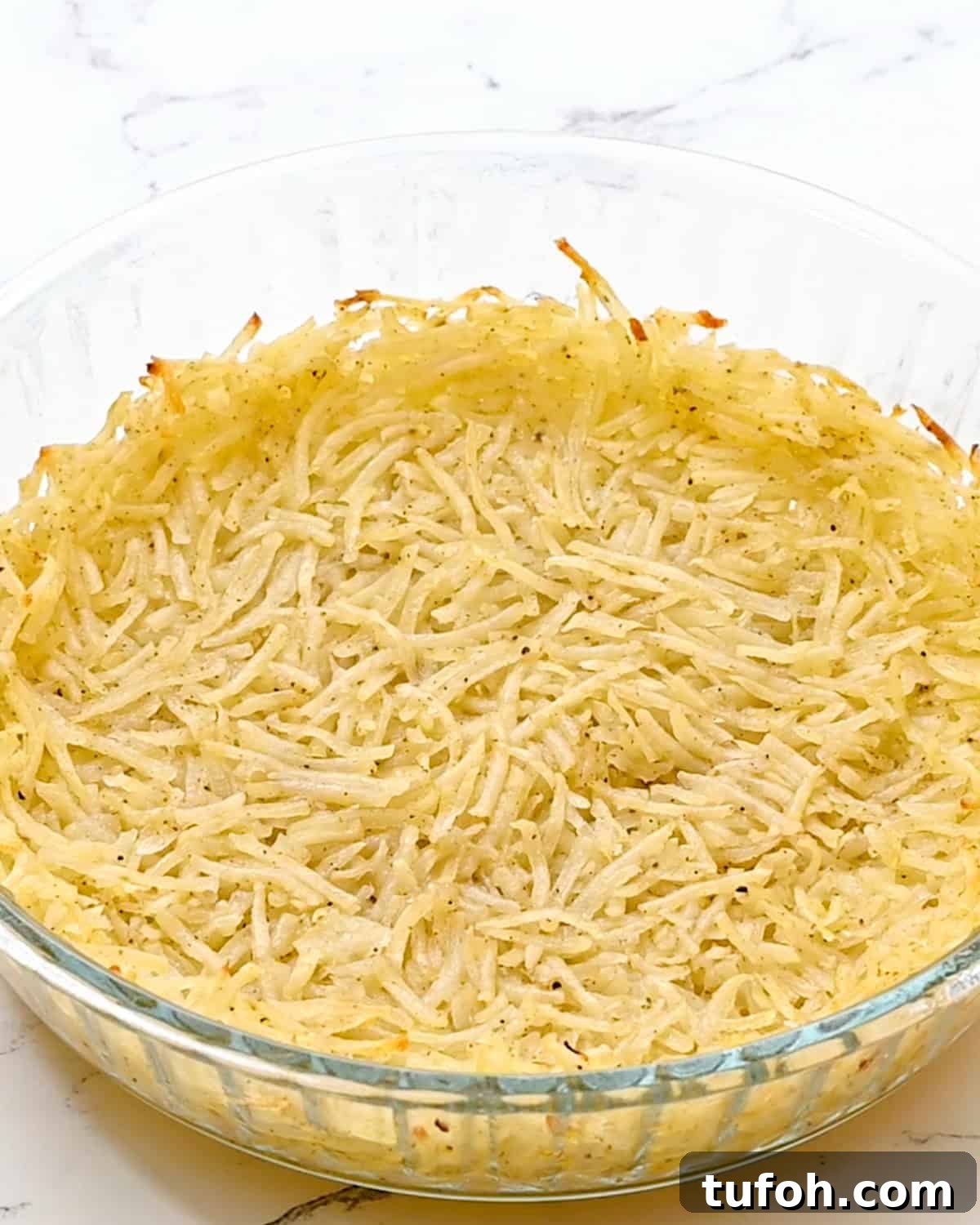 hash brown crust in a pie dish after baking